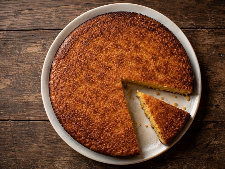 Golden cornbread turned out of a cast iron skillet